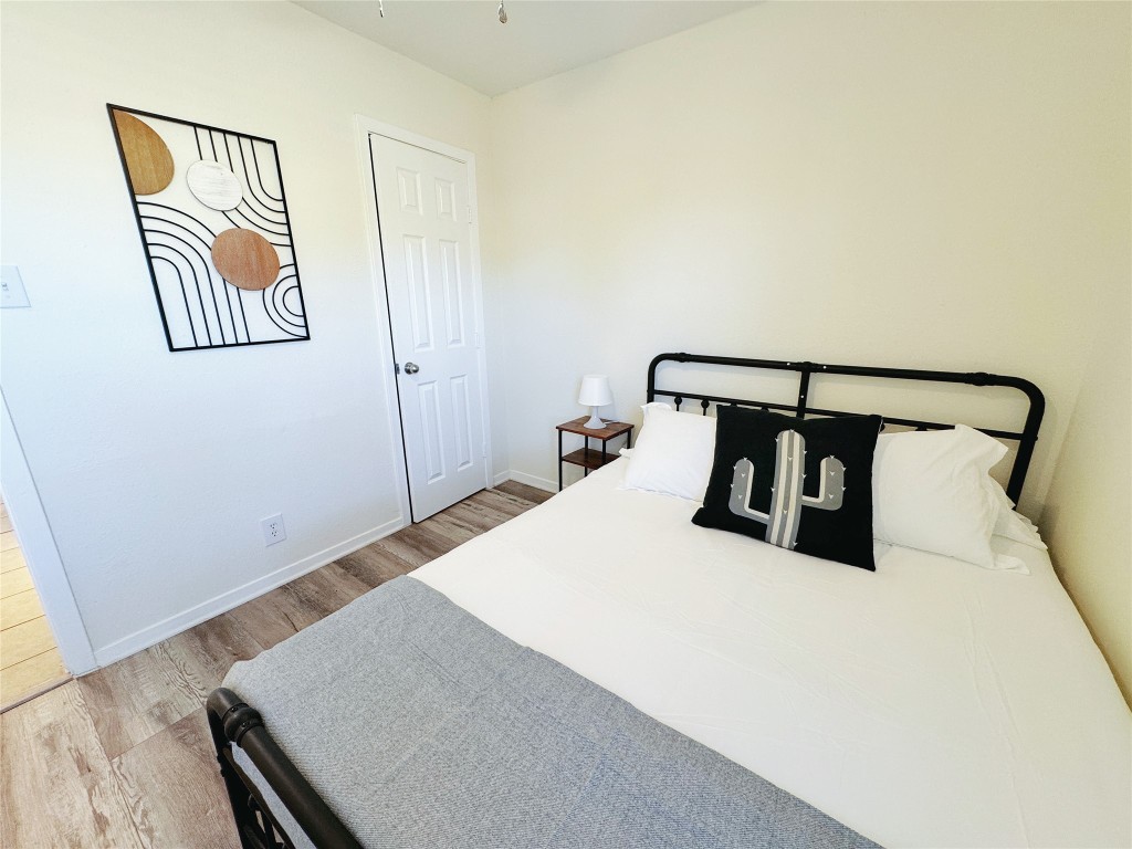 2405 Teri Road Austin, TX 78744 - Photo 12 of 18 a bedroom with a bed and a night stand