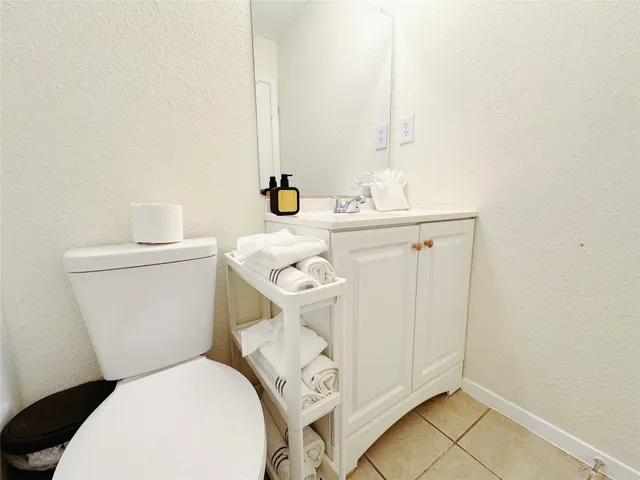 a white toilet sitting next to a bathroom sink