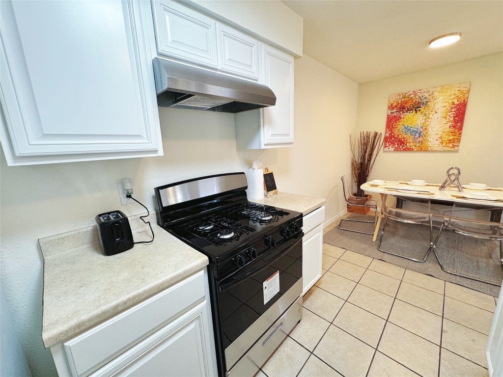 2405 Teri Road Austin, TX 78744 - Photo 2 of 18 a kitchen with a stove and a refrigerator