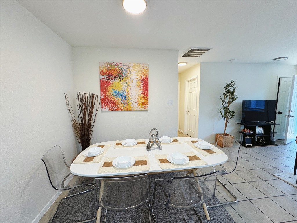 2405 Teri Road Austin, TX 78744 - Photo 3 of 18 a view of a dining room with furniture and wooden floor