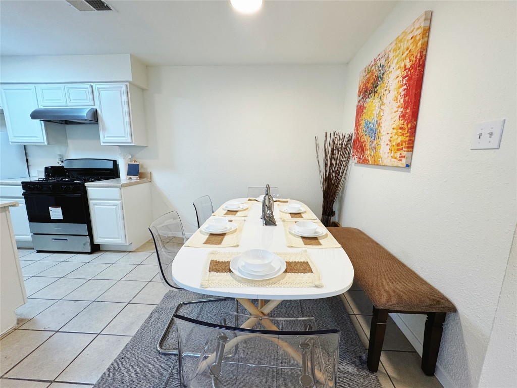 2405 Teri Road Austin, TX 78744 - Photo 4 of 18 a view of a dining room with furniture and wooden floor