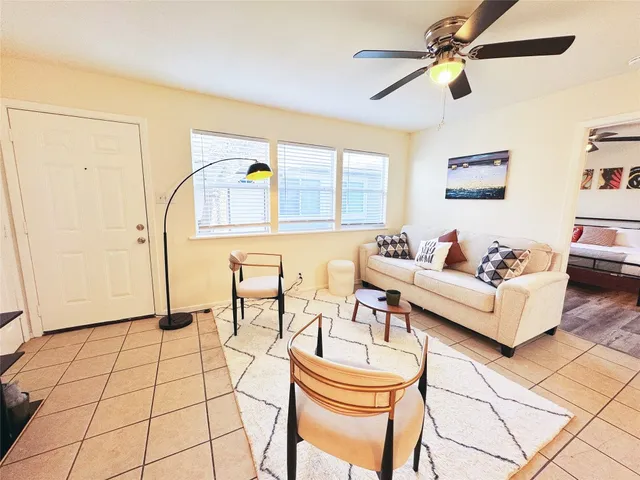 a living room with furniture and a rug