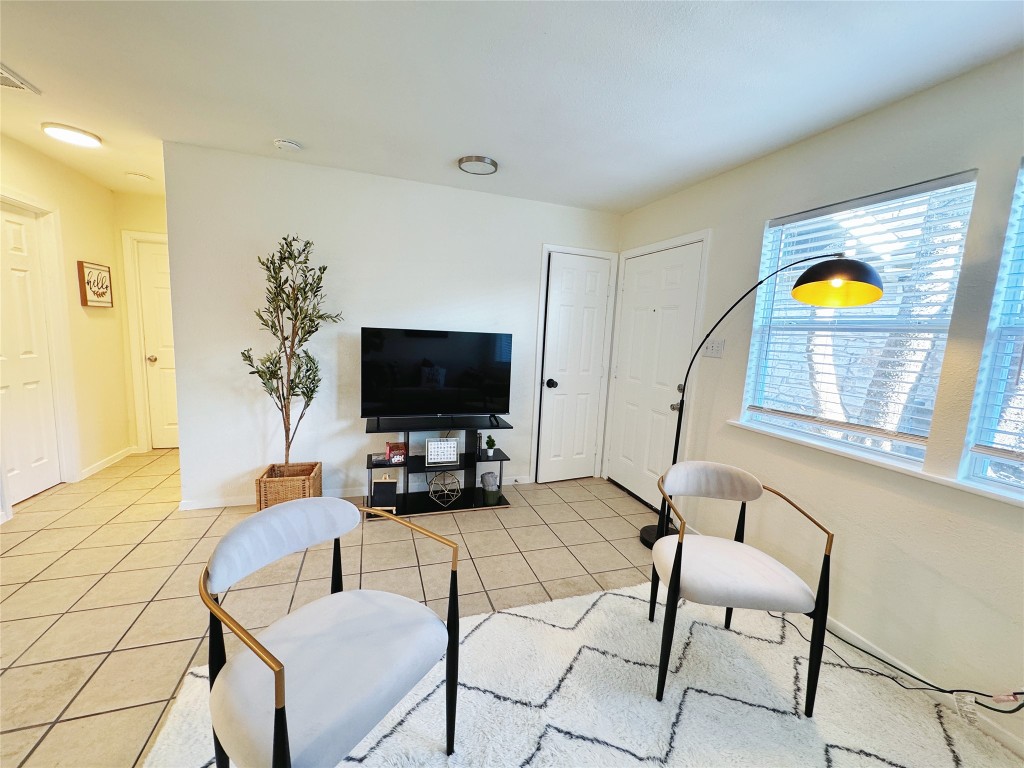 2405 Teri Road Austin, TX 78744 - Photo 7 of 18 a living room with furniture and a flat screen tv