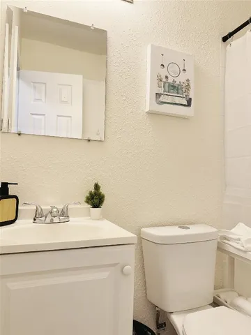 a bathroom with a toilet and a sink