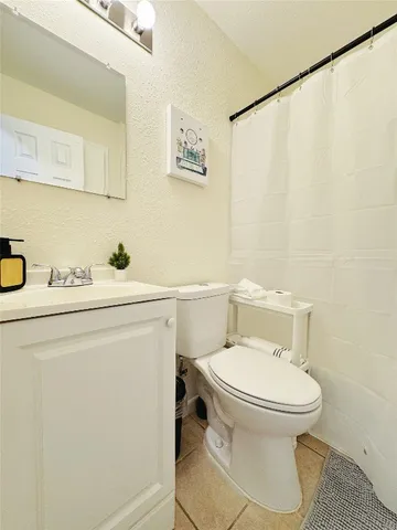 a white toilet sitting next to a bathroom sink
