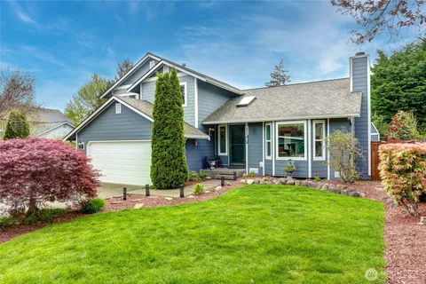 a front view of a house with a yard and porch
