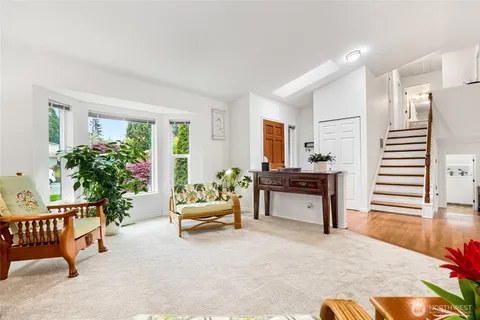 a living room with furniture and a potted plant