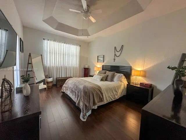 a bed room with a bed window and a chandelier