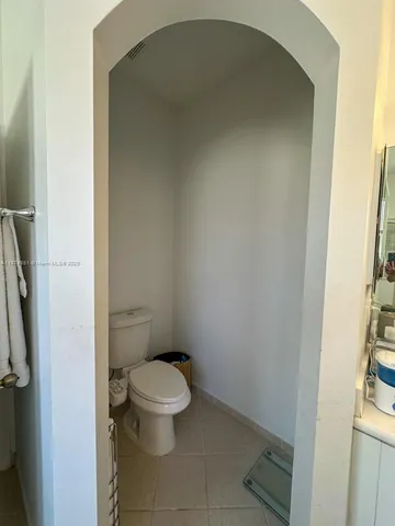 a white toilet sitting next to a bathroom sink