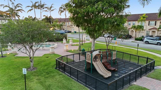 a view of a roof deck with couches and wooden fence