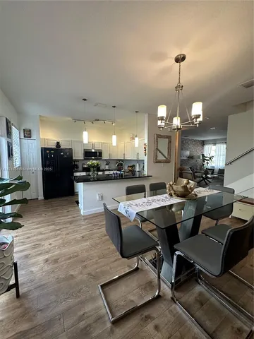 a living room with lots of furniture and kitchen view