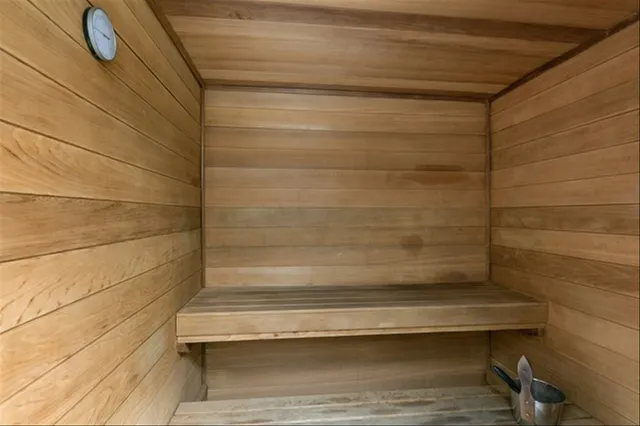 a living room with stainless steel appliances kitchen island granite countertop furniture a rug kitchen view and a chandelier