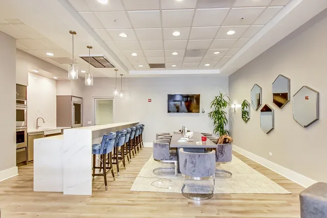a dining room with furniture a rug and wooden floor