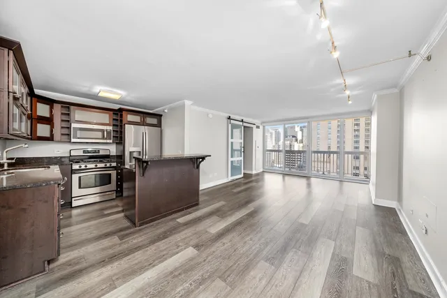 a view of a kitchen with wooden floor
