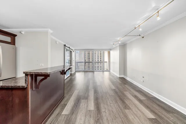 a view of a room with wooden floor