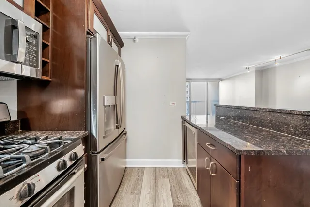 a kitchen with stainless steel appliances granite countertop a stove and a sink