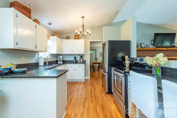 a kitchen with counter top space a sink appliances and cabinets