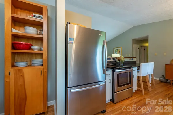 a metallic refrigerator freezer sitting in a kitchen