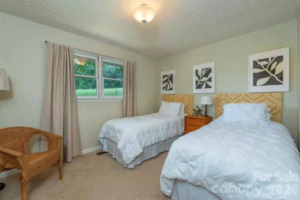 a bedroom with two beds and a window