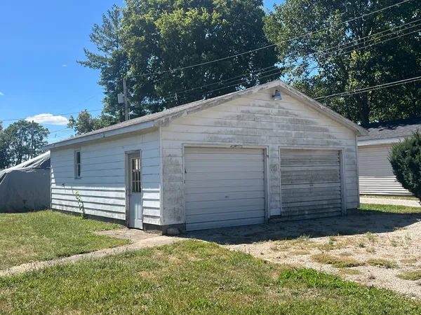 a view of wooden house and a yard