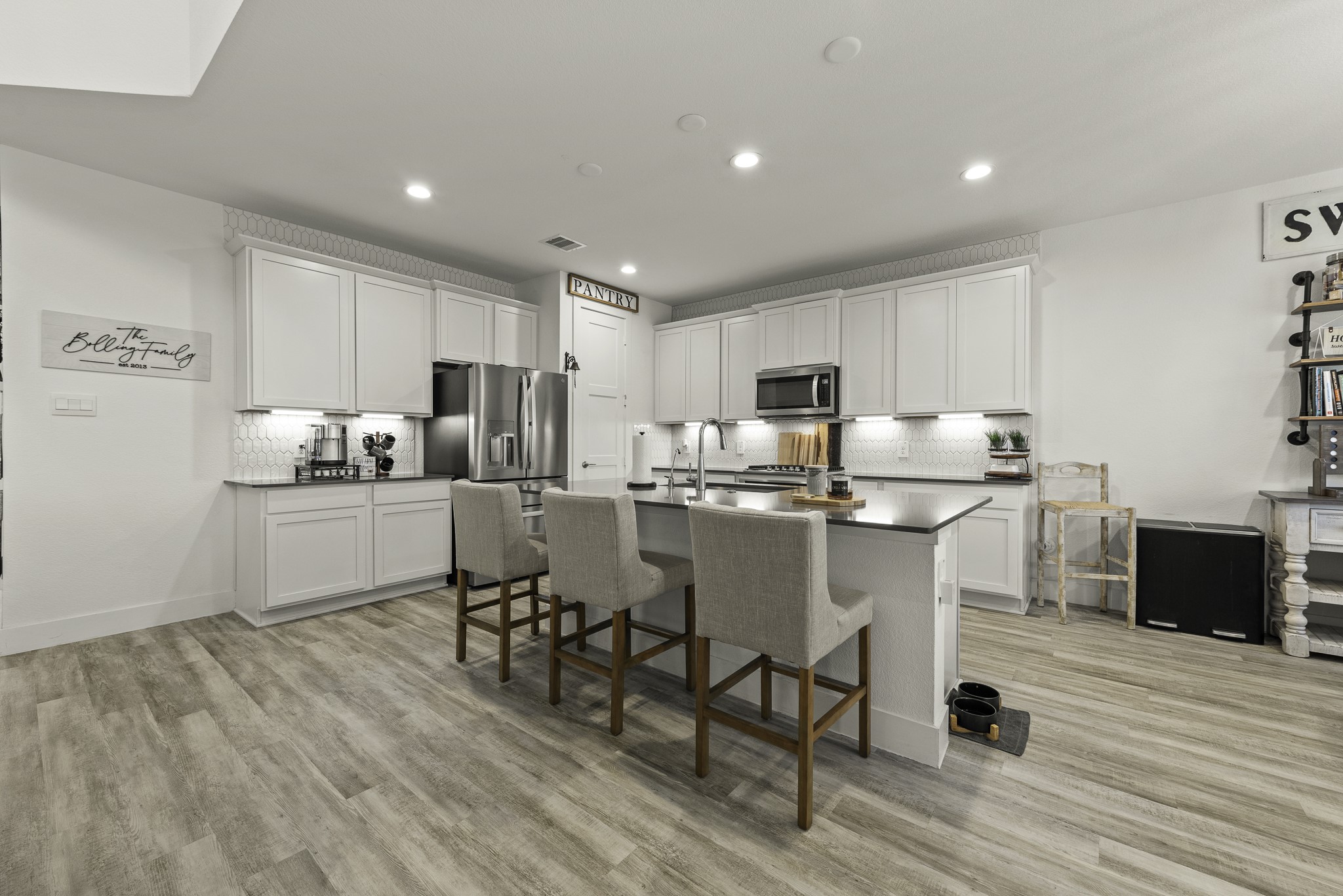 10009 Gray Jay Court Conroe, TX 77384 - Photo 13 of 47 a kitchen with a table chairs refrigerator and cabinets
