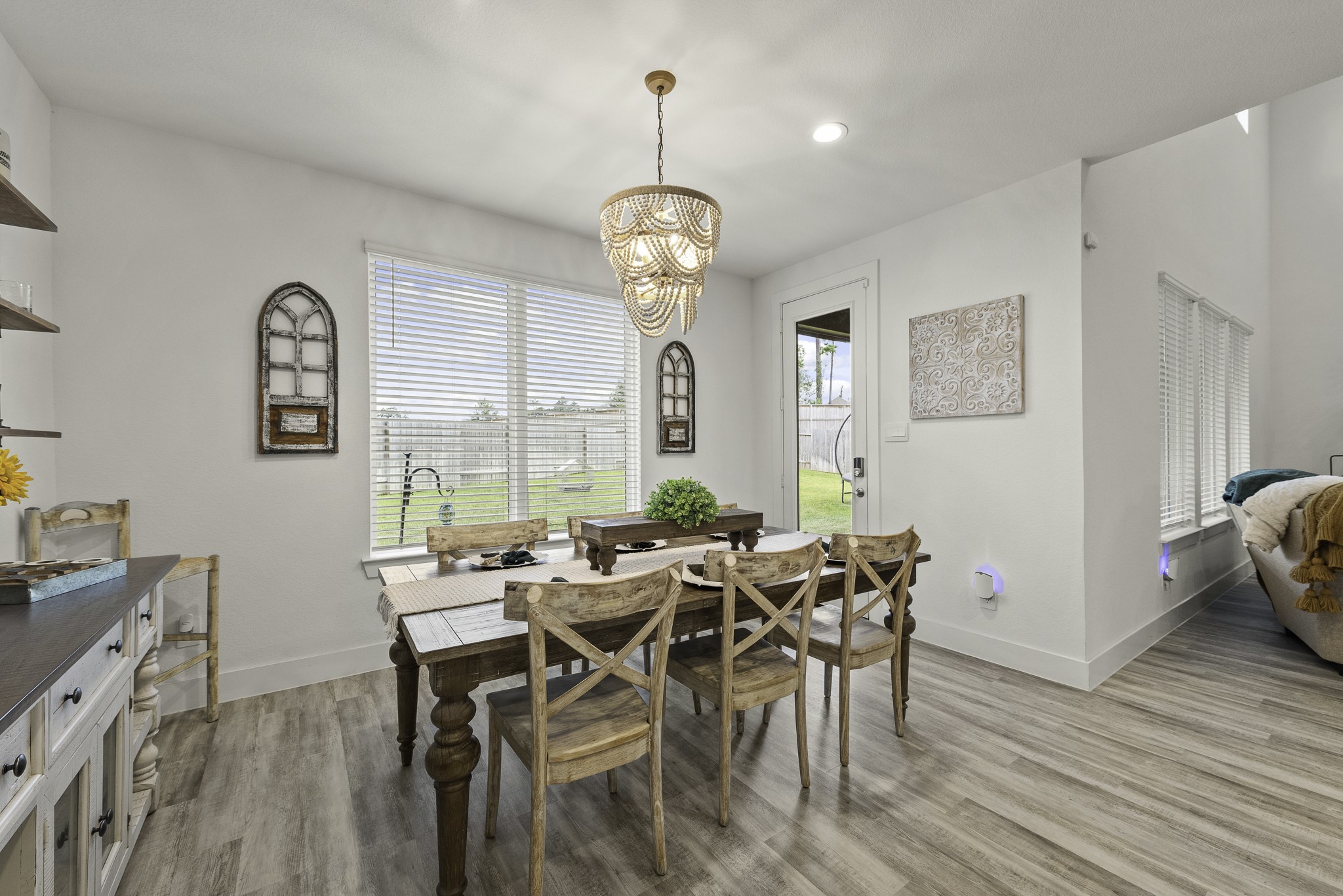 10009 Gray Jay Court Conroe, TX 77384 - Photo 18 of 47 a view of a dining room with furniture window and wooden floor