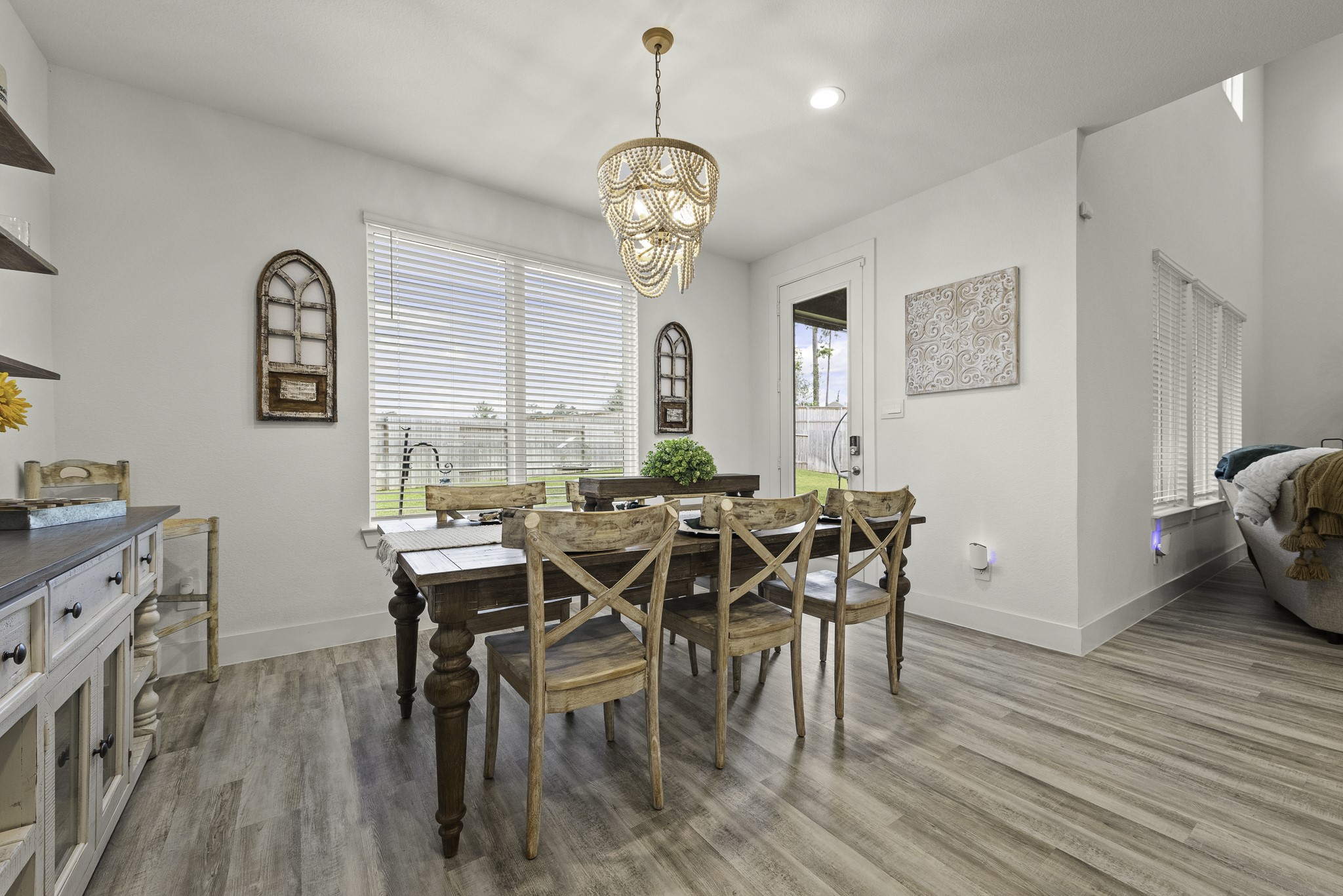 10009 Gray Jay Court Conroe, TX 77384 - Photo 19 of 47 a view of a dining room with furniture window and wooden floor