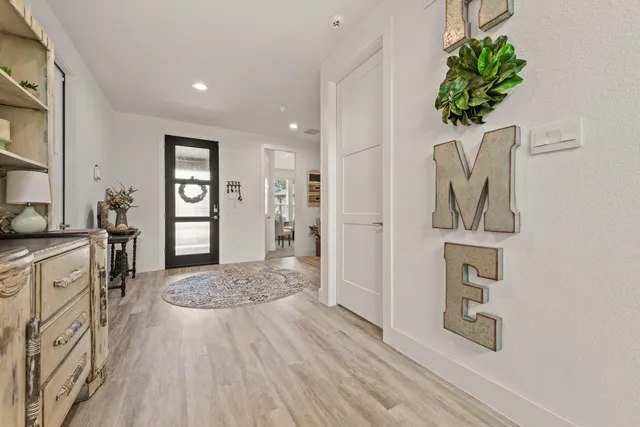 a view of a livingroom with wooden floor and a window