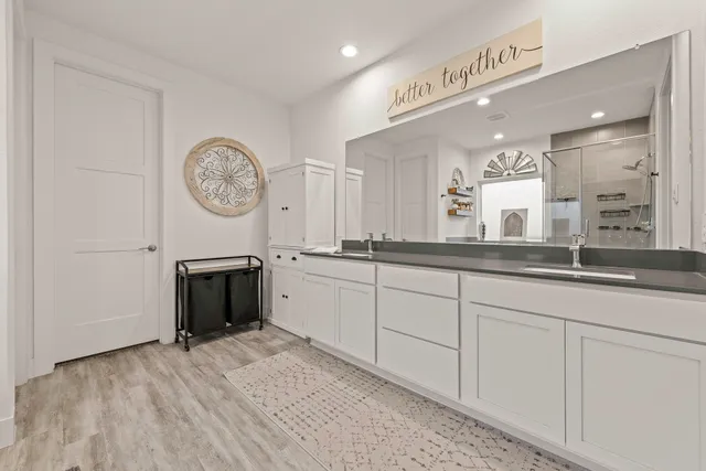 a bathroom with a sink a mirror and a shower