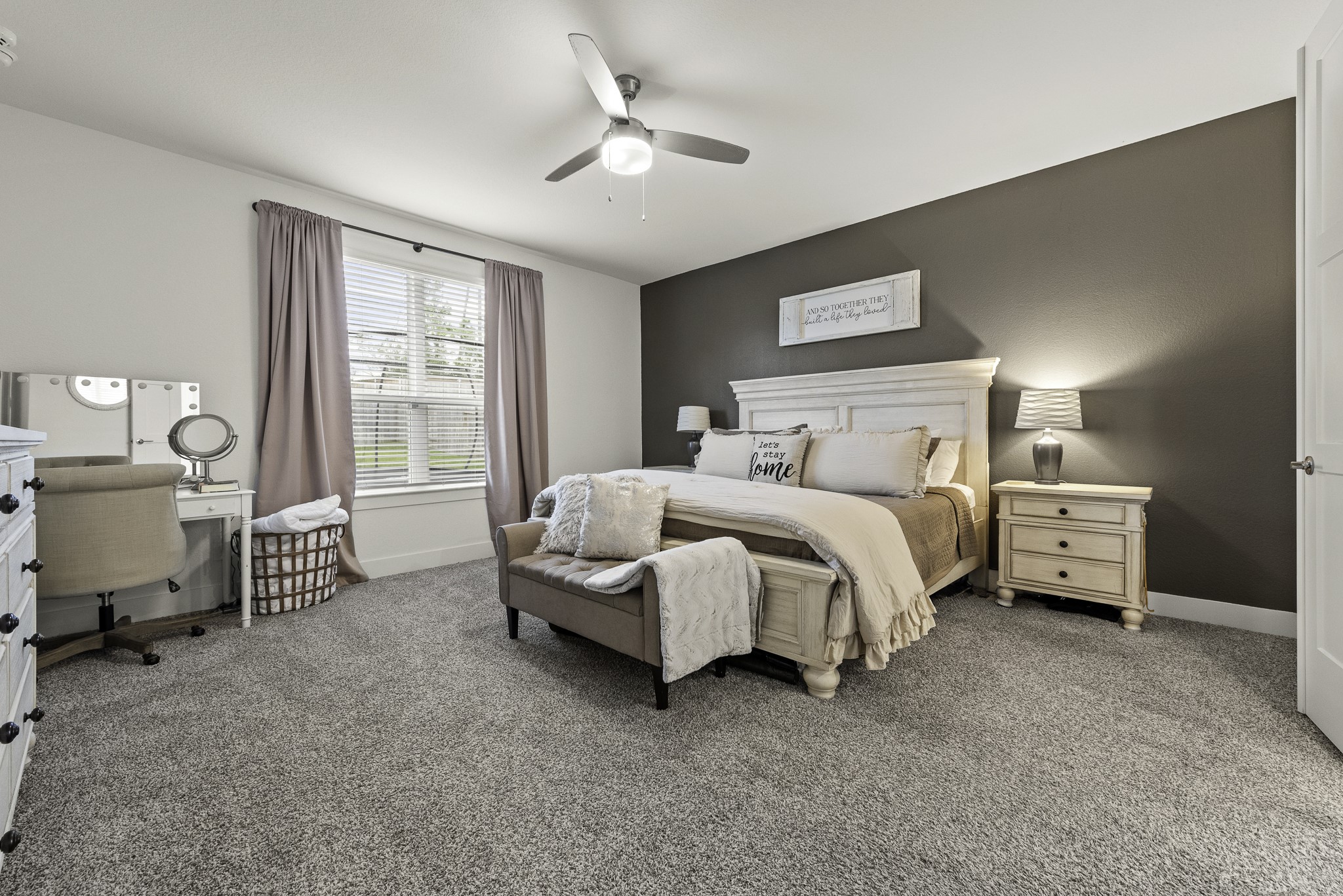 10009 Gray Jay Court Conroe, TX 77384 - Photo 26 of 47 a bedroom with a bed and a chandelier