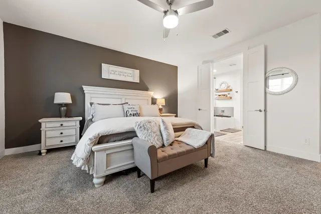 a bedroom with furniture and a flat screen tv