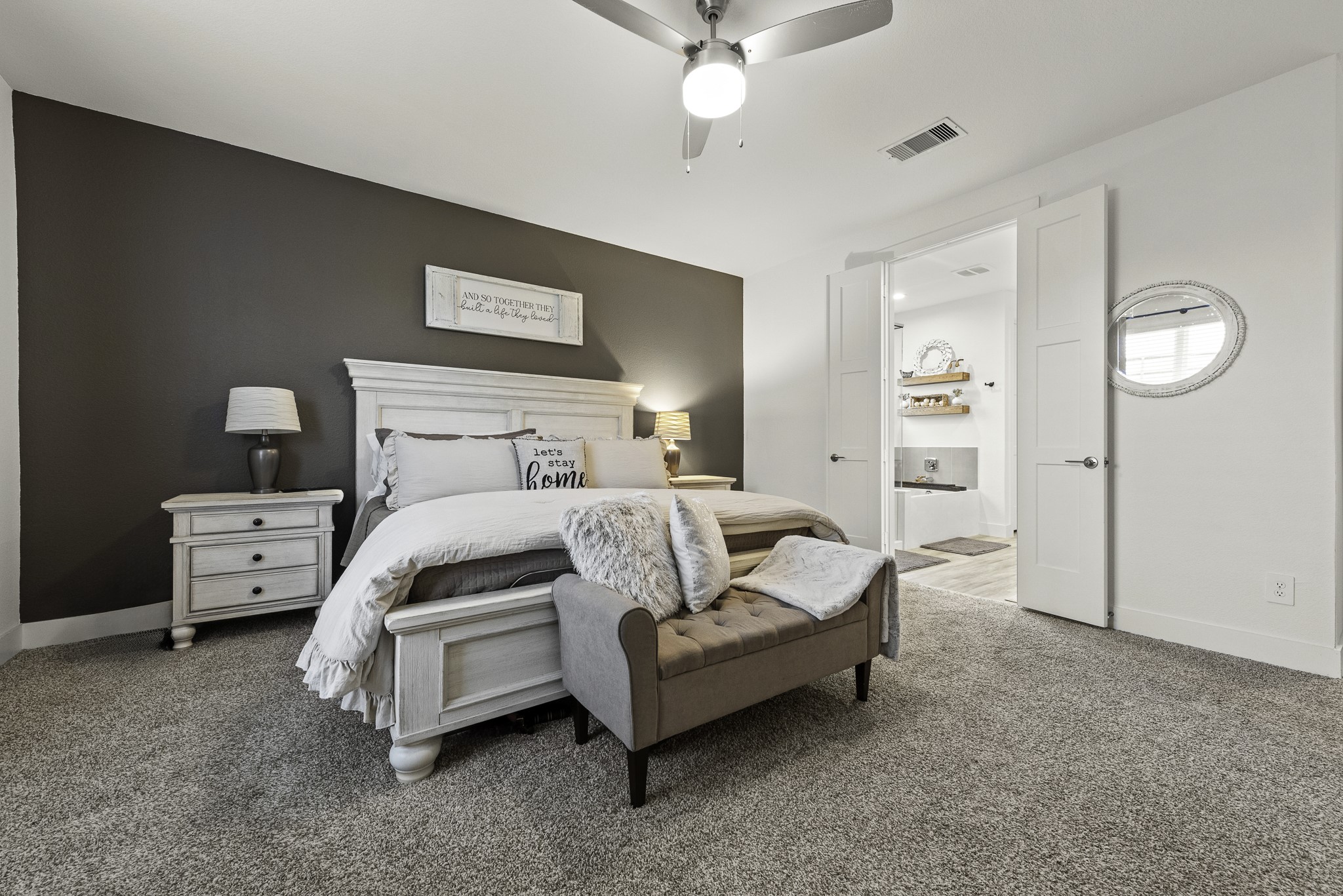 10009 Gray Jay Court Conroe, TX 77384 - Photo 27 of 47 a bedroom with a bed and a chandelier