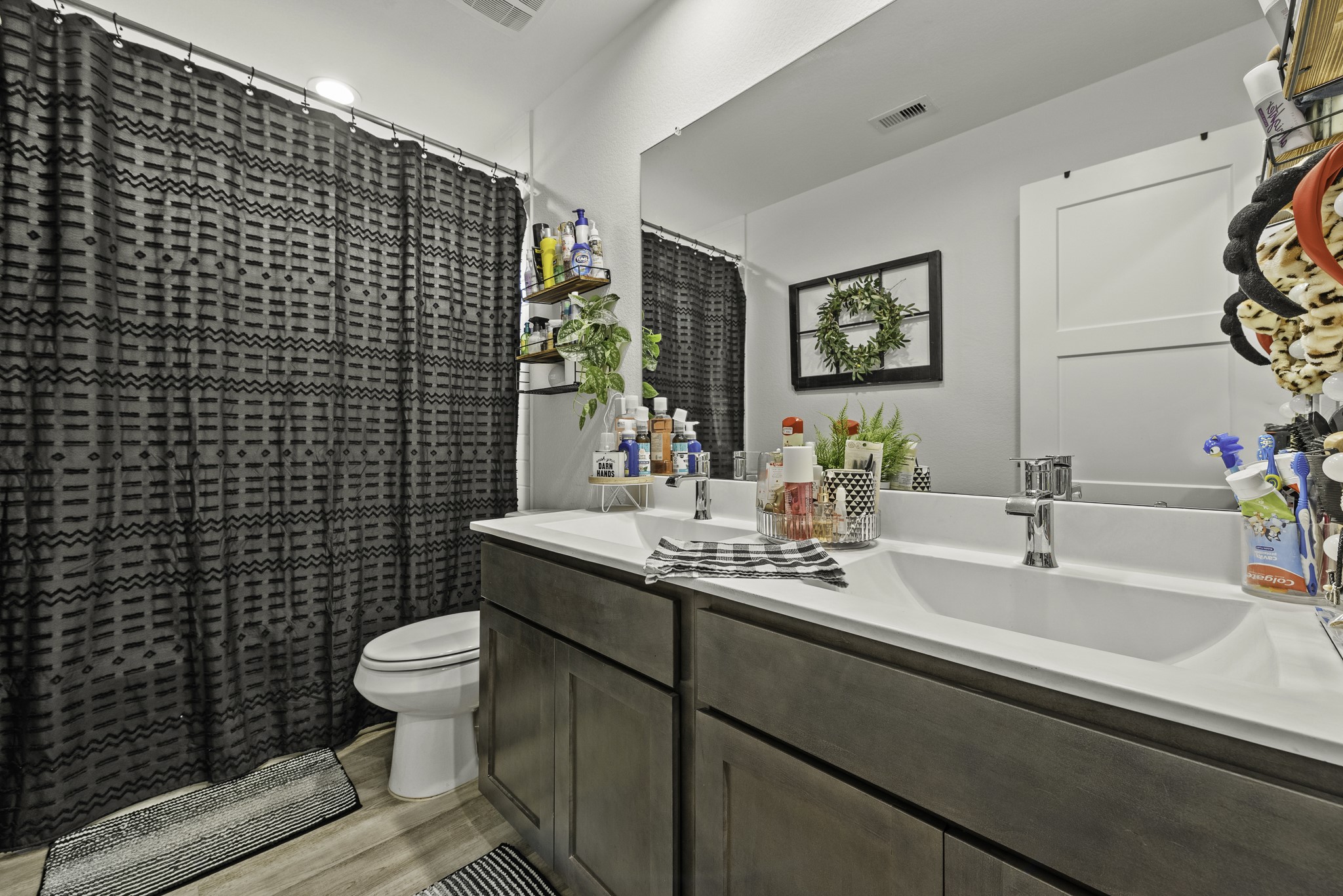 10009 Gray Jay Court Conroe, TX 77384 - Photo 30 of 47 a bathroom with a sink toilet and mirror