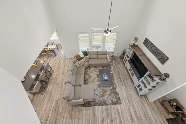 a view of a house with a big yard plants and large trees