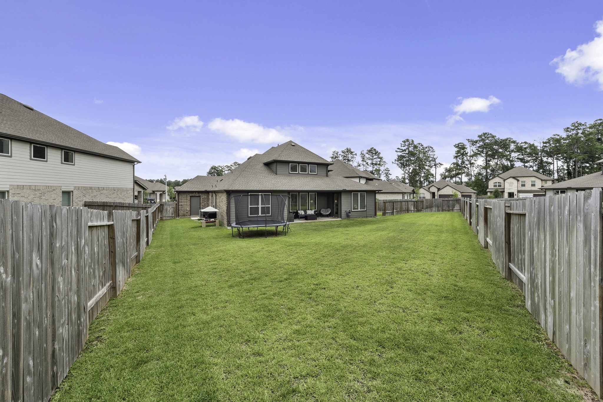 10009 Gray Jay Court Conroe, TX 77384 - Photo 40 of 47 a view of a house with a big yard plants and large trees