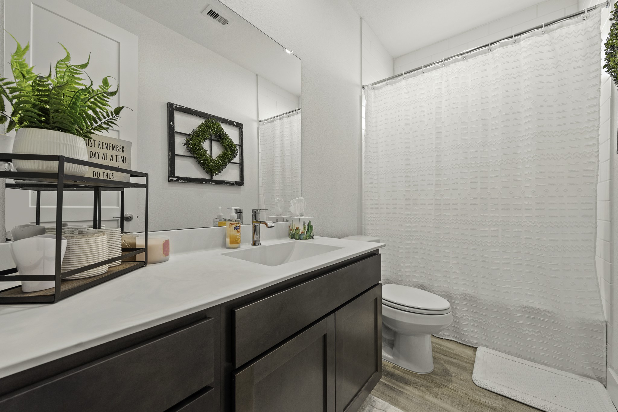 10009 Gray Jay Court Conroe, TX 77384 - Photo 6 of 47 a bathroom with a sink a toilet and a mirror