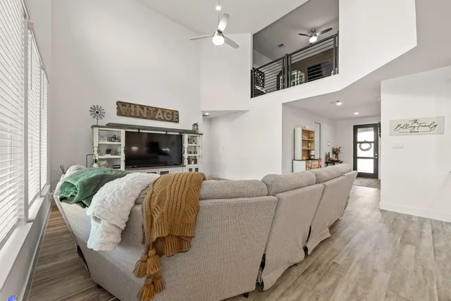 a living room with furniture and a wooden floor