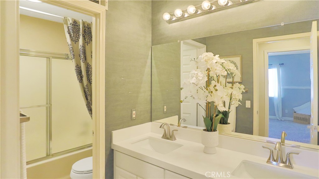 3759 Dewcrest Court Chino, CA 91710 - Photo 23 of 45 a bathroom with a granite countertop sink toilet and shower