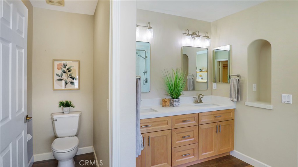 3759 Dewcrest Court Chino, CA 91710 - Photo 27 of 45 a spacious bathroom with a granite countertop sink a toilet and a large mirror