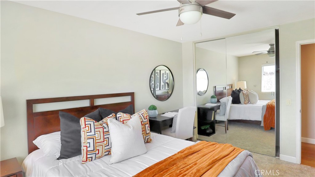 3759 Dewcrest Court Chino, CA 91710 - Photo 32 of 45 a bed room with a bed a mirror and a chandelier