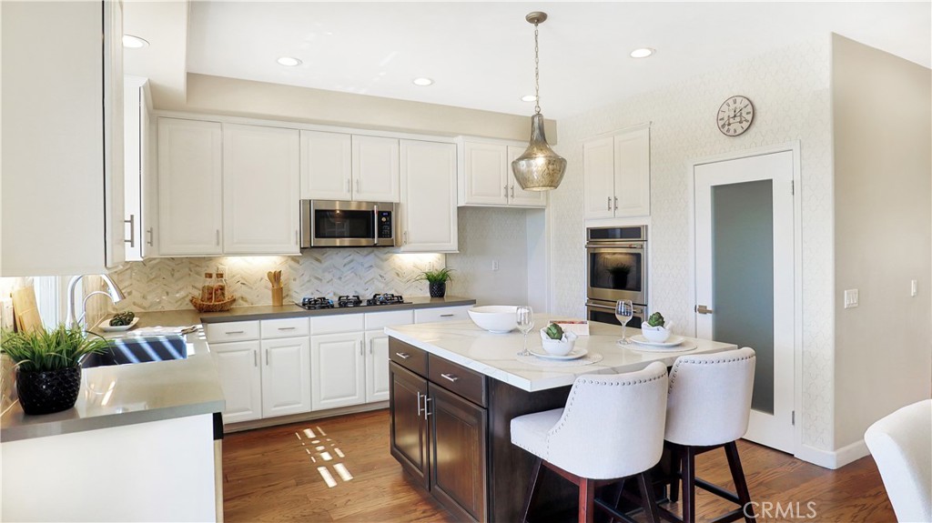 3759 Dewcrest Court Chino, CA 91710 - Photo 5 of 45 a kitchen with a sink a microwave and white cabinets