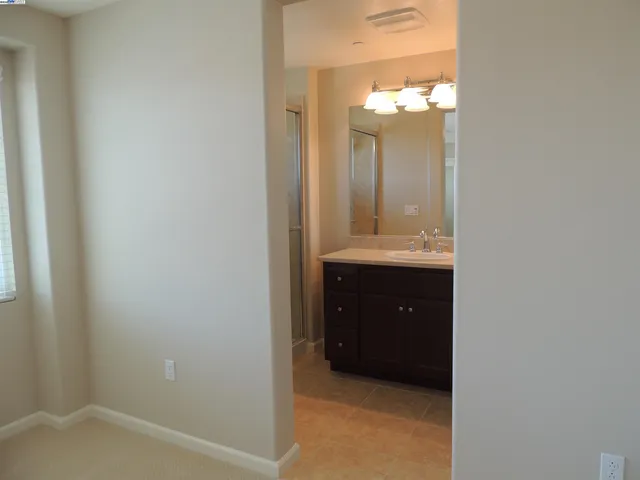 a bathroom with a sink a mirror and a vanity