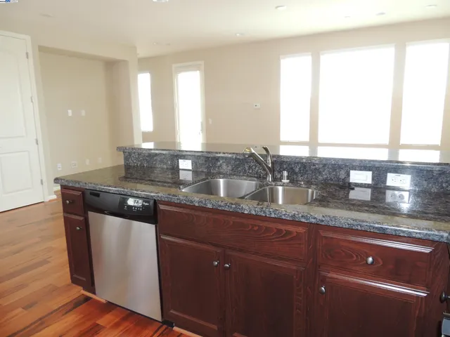 a kitchen with granite countertop a sink and a window