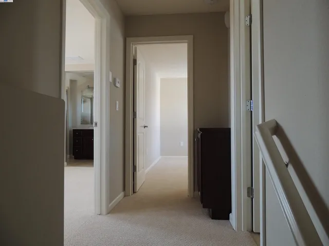 a view of hallway with stairs and a closet