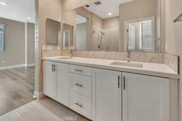 a bathroom with a granite countertop sink mirror and double