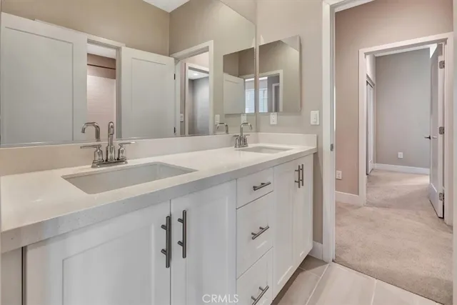 a bathroom with a sink double vanity and a mirror