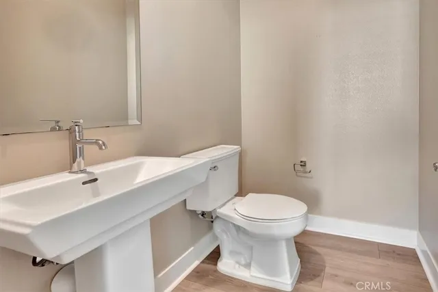 a view of a white building among the street with palm trees