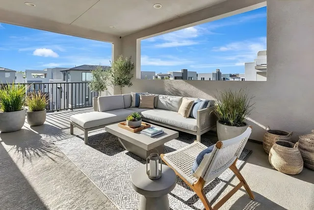 a view of a patio with couches and potted plants