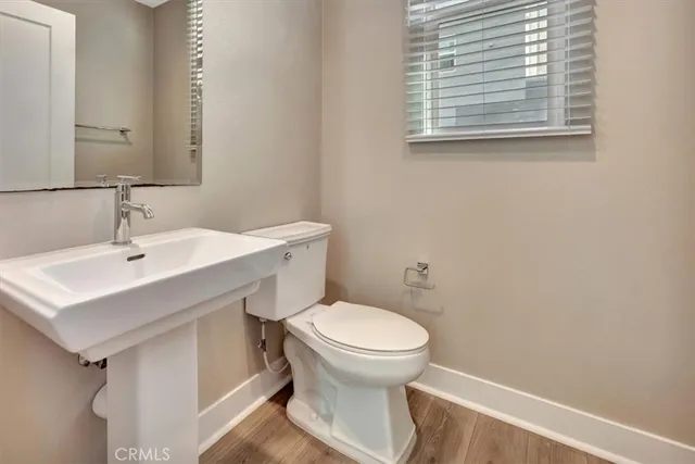 a bathroom with a sink toilet and a mirror