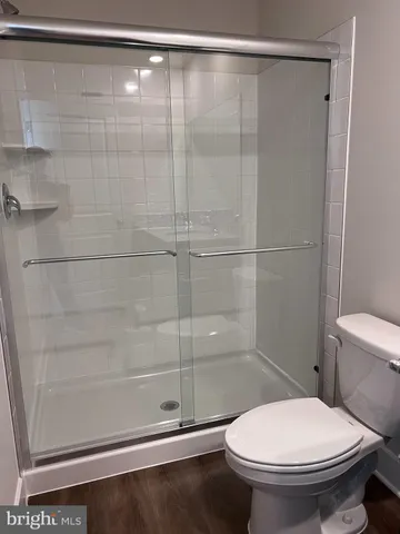 a bathroom with a toilet and a shower